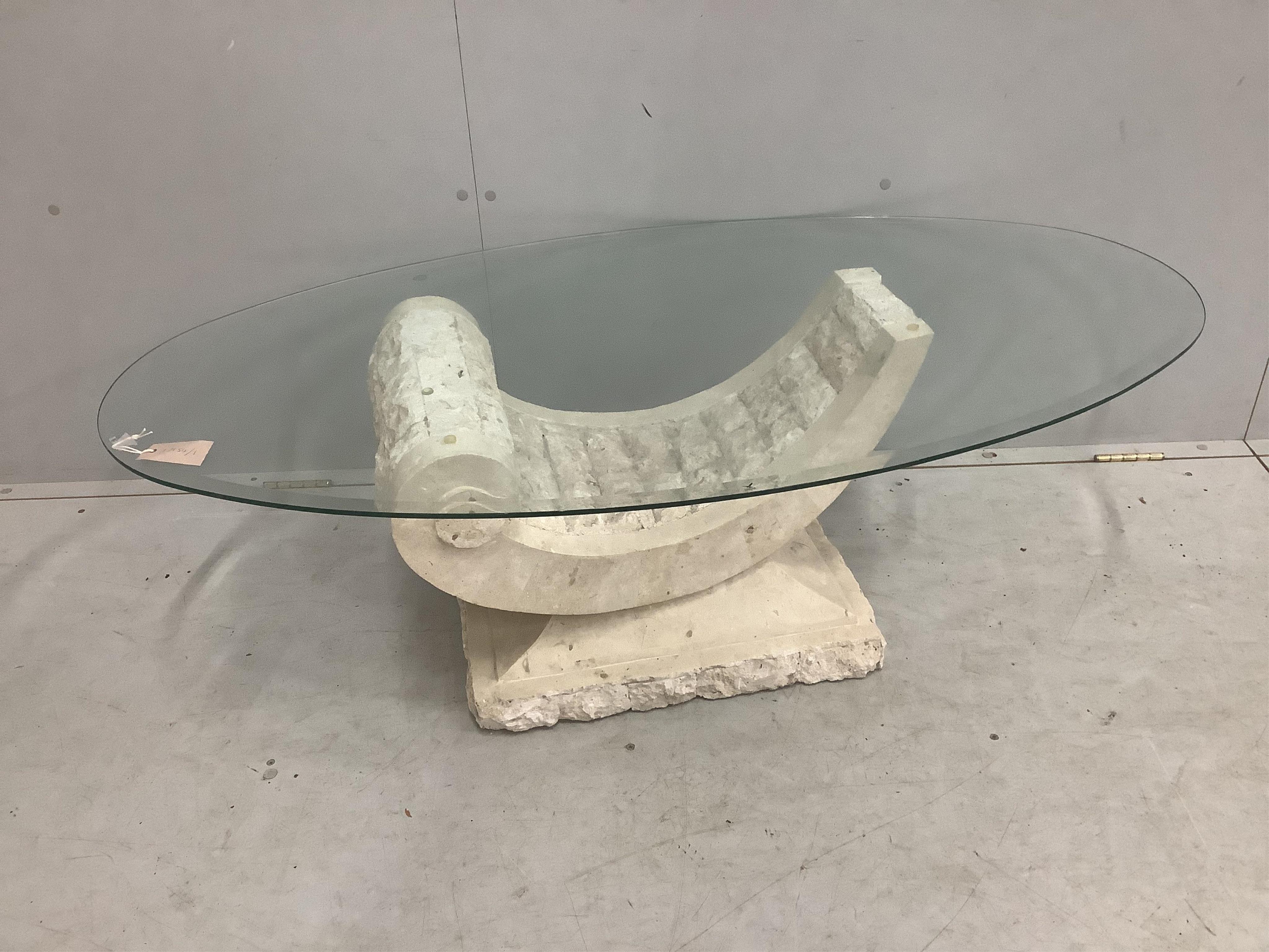 A Contemporary Italian design oval glass coffee table on composite 'C' scroll base, width 130cm, depth 70cm, height 41cm. Condition - good